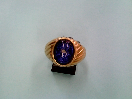 721: One custom made 10k yellow gold man s ring set with 11x8 mm oval pruple/blue dichoric Inclusion tm diamond stone 