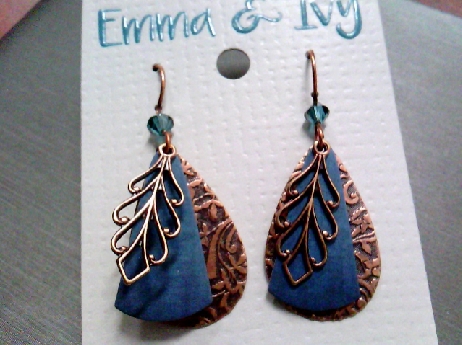 932: Emma Ivy Copper colored metal dangle earrings on fishwires with a turquise blue color laser engraved trillion disc.