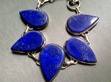 990: One ladie sterling silver bracelet set with five pear shaped genuine Lapis Lazuli stones with a toggle style clasp