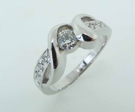 14KW Studio Tzela engagement ring set with: - - 0.248ct Hearts On Fire Diamond; J; VS2 HOF2023058 - AGS104095969017 - - 8 Hearts On Fire diamonds; 0.11cttw; G/H; VS-SI