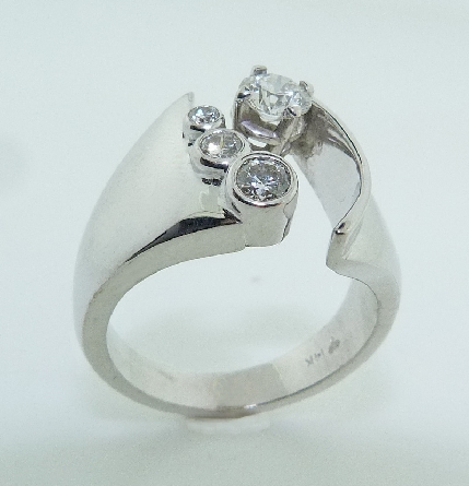 14KW diamond engagement ring by Studio Tzela set with:
- 0.331ct G; SI1 ideal cut; round brilliant cut diamond by Hearts On Fire; HOF101530
- accented with 3 ideal cut; round brilliant cut diamonds by Hearts On Fire: 0.14ct; 0.066ct; and 0.024ct -