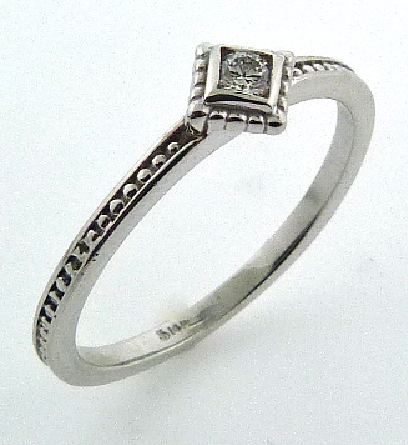 14 karat white gold stackable diamond ring.
Set with one 0.056 carat H; SI1 ideal round brilliant cut diamond by Hearts On Fire.