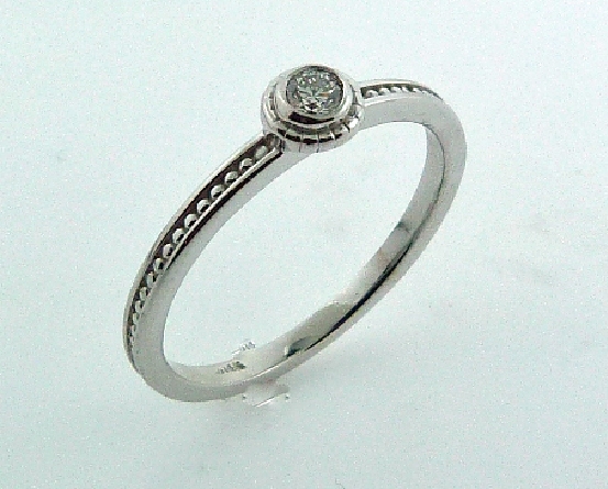 14 karat white gold stackable diamond ring.
Set with one 0.079 carat H; SI1 ideal round brilliant cut diamond by Hearts On Fire.