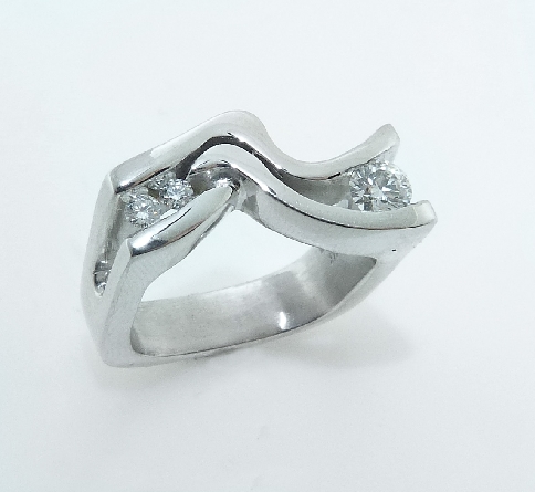 14K white gold lady s right hand ring; set with one 0.263 carat H SI1 ideal round brilliant cut non-serialized diamond by Hearts On Fire. Accented with two G/H SI ideal round brilliant cut diamond by Hearts On Fire; totaling 0.081 carat. -