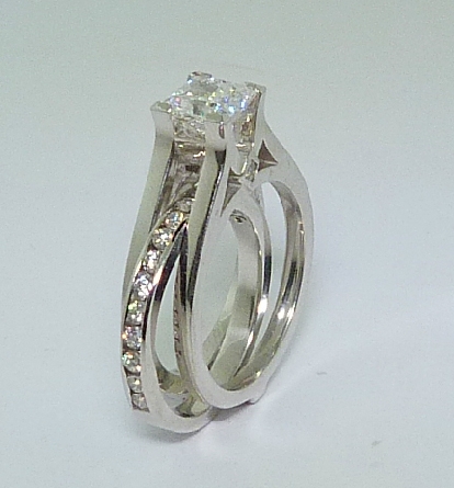 18KW gold sleeve design engagement ring - with matching band insert. - Set with: - -FireMark=1.07ct F SI1 - -2*= 0.04cttwSI1G/H - -15*= 0.46cttwSI1-2G/H Band