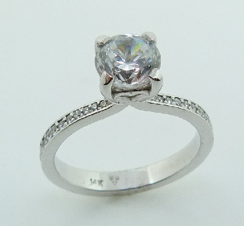 One lady s 14K white gold diamond engagement ring. - Set with 28 round brilliant cut diamonds totalling 0.165carats; SI1/VS2; F/G excellent cut. - - Set in the center with a 0.75ct CZ