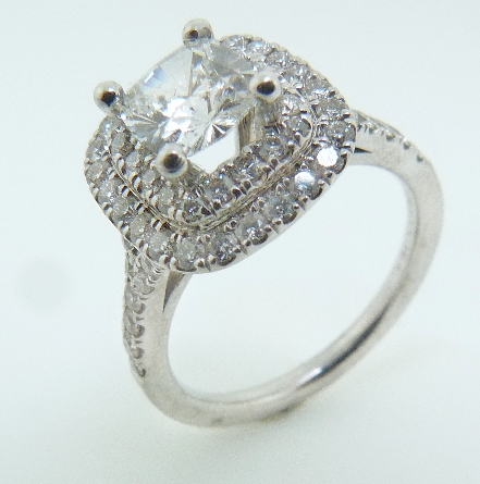 14 karat white gold engagement ring. - Set with one 0.71 Fire Cushion; G; VVS; Cushion Brilliant Cut; GIA #1166054864 - Accented with 0.57 carat total weight; SI; G/H.