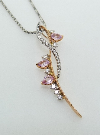 18KWR diamond and sapphire pendant by Parade set with:
- 29 round brilliant cut diamonds; G/H; SI
- 3 pink pear cut sapphires; 0.42 cttw