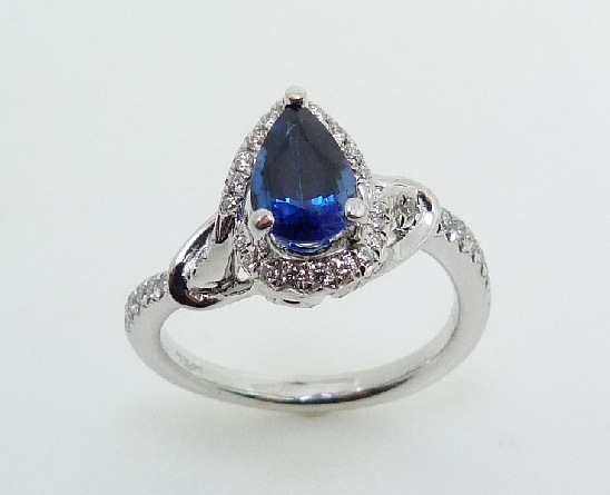 18KW coloured gemstone ring by Parade Designs set with:
- 0.95ct pear shaped blue sapphire
- 47 round brilliant cut diamonds; 0.26cttw; G/H; SI1-2